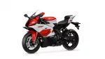 Red and white Yamaha sport motorcycle photographed from the front-left, showing its aerodynamic fairing and exposed front brake discs
