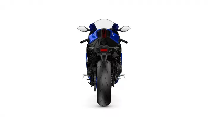 Rear view of a blue sport motorcycle on a white background, showing taillight and mirrors.