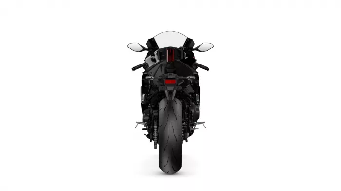 Rear view of a black sport motorcycle on a white background with a prominent red taillight
